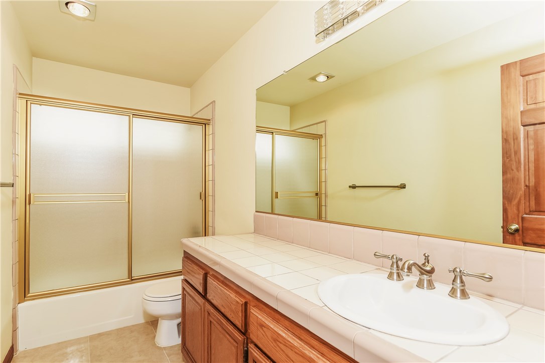 The lower level full bath is well sized with a tub, large vanity, bright lighing and a full wall mirror