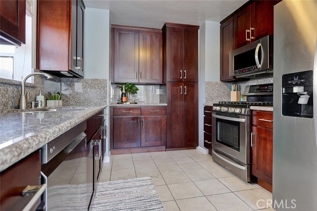 Remodeled kitchen has a brand new stainless refrigerator and dishwasher.