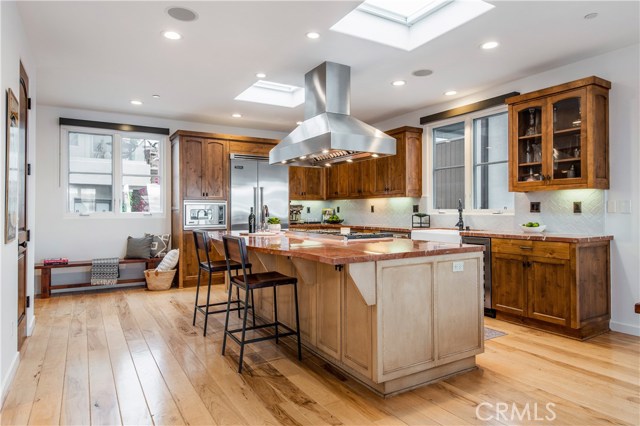 Island features a bar with seating for 4-6 people, great for casual dining and entertaining.