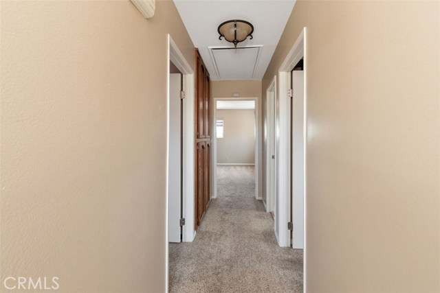 Upstairs hallway leading to bedrooms and pull down attic access