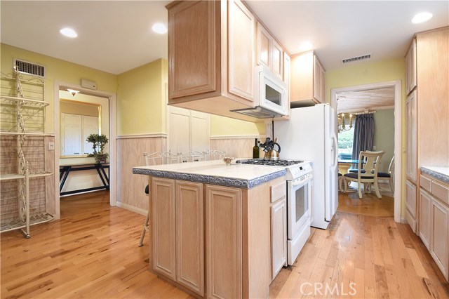 Entries to kitchen from entry hall and dining room