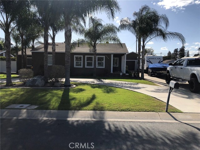 Front of home, circular driveway and RV parking