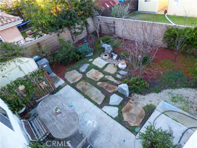 View of garden with tea-ceremony water fountain, garden table and chairs
