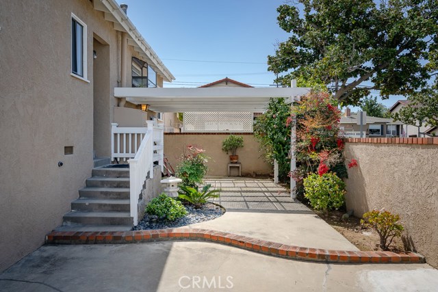 Covered entertainment area professionally landscaped