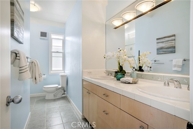 Hall bath upstairs.  Double vanity.  Tub is ahead and to the left.