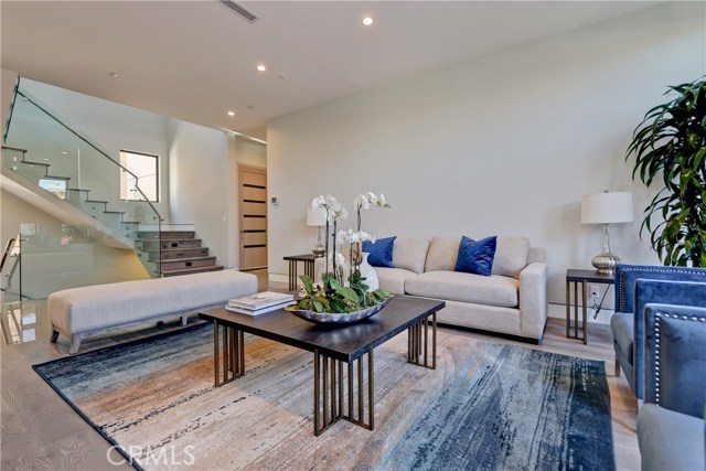 Living room open to floating staircase and 3 stop elevator