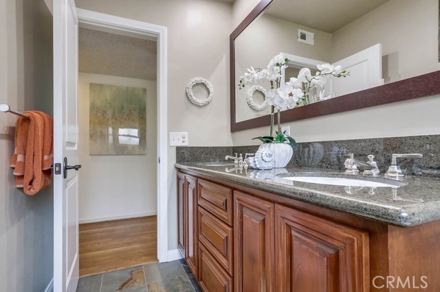Remodeled hall bath featuring double sinks and a large walk in shower