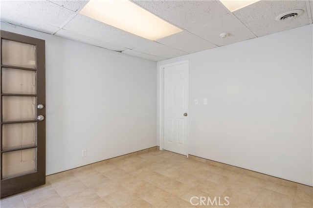 This is the downstairs bonus room adjacent to garage. It is not included in the 1296 sq ft of the unit.