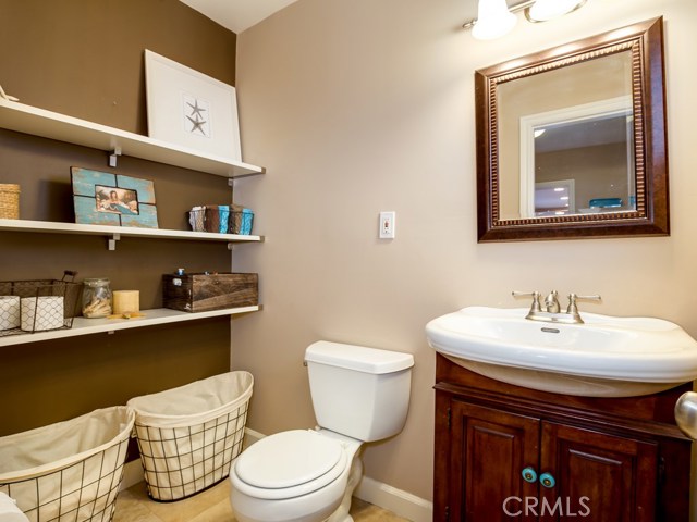 Guest bath with travertine floors and storage!