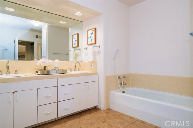 Dual sinks and a separate bath tub and enclosure shower.