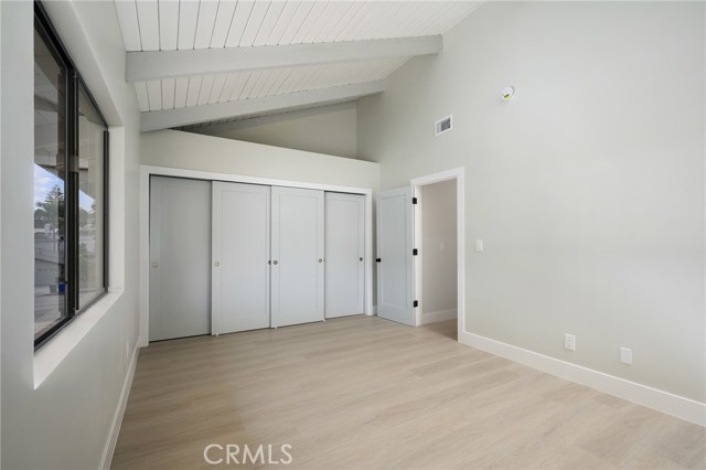 2nd bedroom upstairs with vaulted ceiling and builtin closet