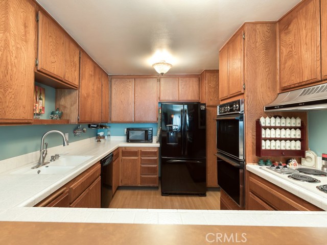 Kitchen is very large with wood floors and has a ton of cabinetry!