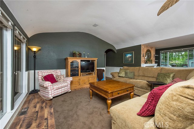 Living room with barreled ceilings, laminate flooring & surround sound