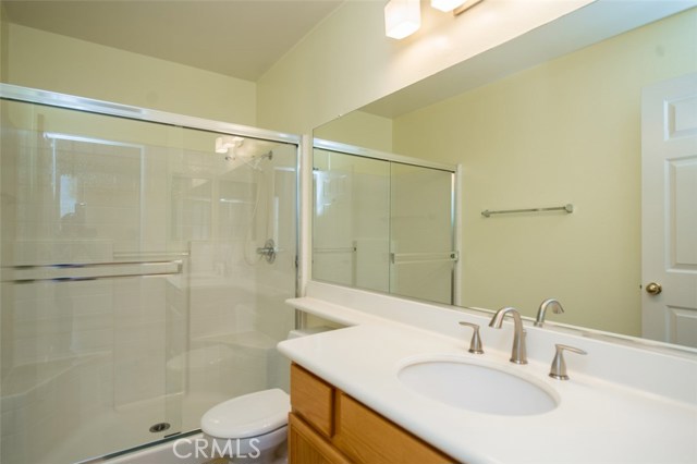 Downstairs bathroom with bathtub shower and sliding shower doors