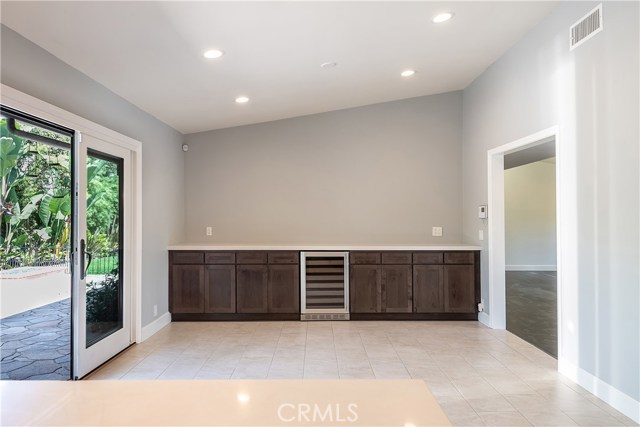 Dining room banquette provides plenty of storage and serving surface, plus a wine refrigerator. This room has a great view of the outdoor kitchen.