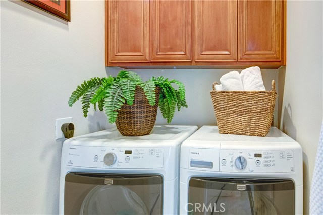 Downstairs separate laundry room with storage cabinets.