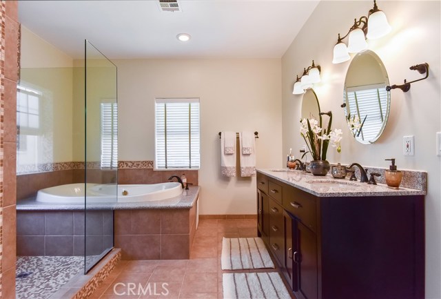 Master bath with double sinks, spa tub and separate shower
