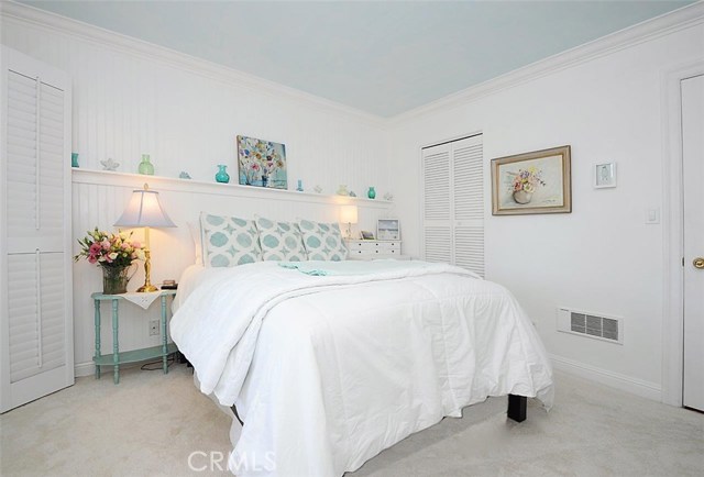 Bedroom with Wainscoting, Plantation Shutters and Walk-in Closet