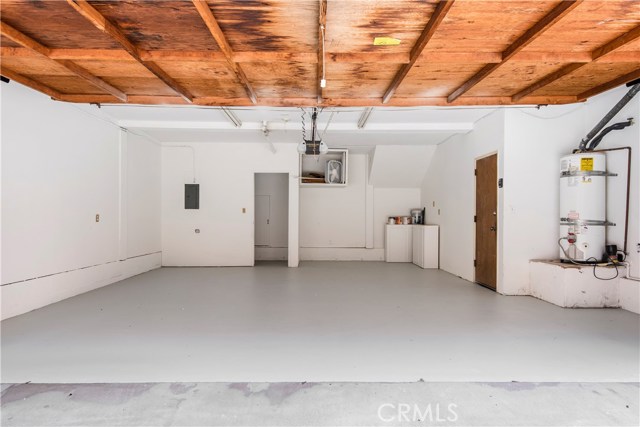 Small storage room in garage with additional storage under townhome