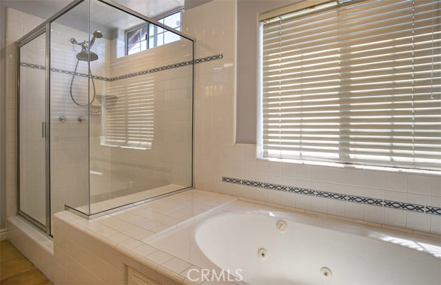 Master bath includes separate shower enclosure and spa tub