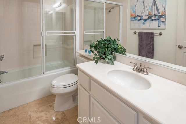 lower level Full guest Bath with Travertine floor tile.