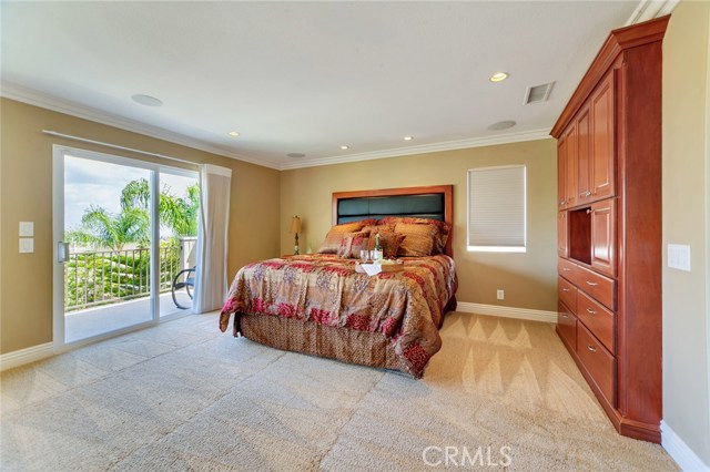 Spacious Master bedroom with panoramic city and mountain views. Balcony slider equipped with remote controlled black-out screen. Window coverings include Hunter-Douglas remote controlled honeycomb shades.