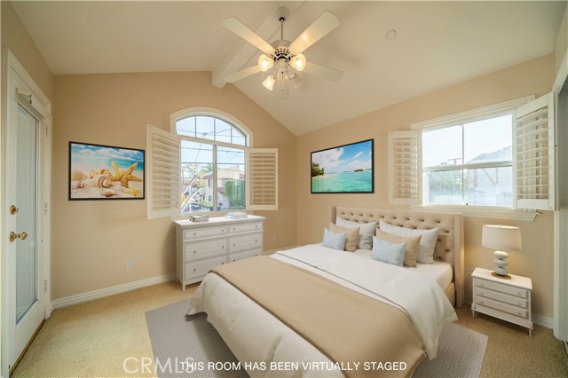 Bedroom featuring plantation shutter and ceiling fan with access to outdoor deck and city light views