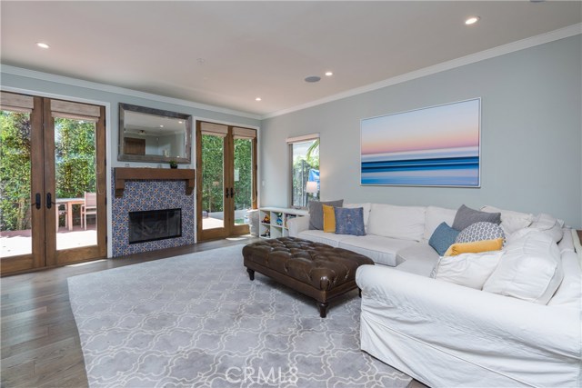 Another view of the living room.  Ceilings are 9 feet, and the doors throughout are all 8 ft!  Owner updated the fireplace with beautiful Mexican tiles.
