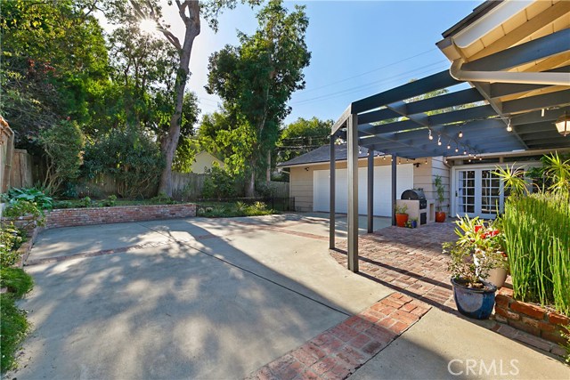 Driveway leads from Palos Verdes Drive onto driveway that leads down to back side of house to the garage.  Access to the kitchen is on this side of the house, and is convenient for unloading directly into the house just beyond the gate.