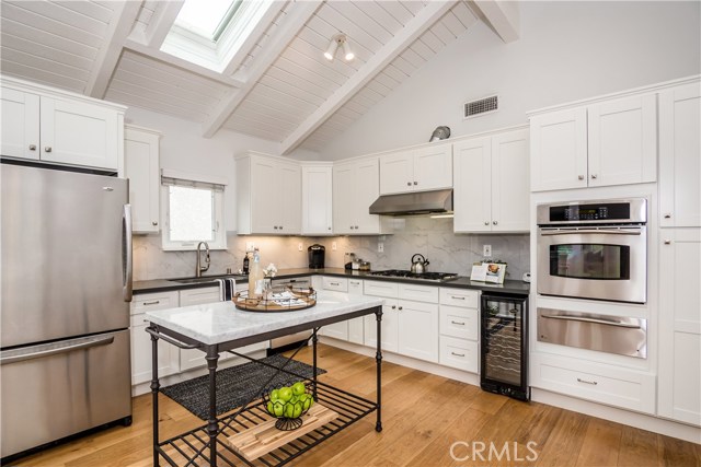 Upgraded modern kitchen features newer cabinets, counter tops, and appliances