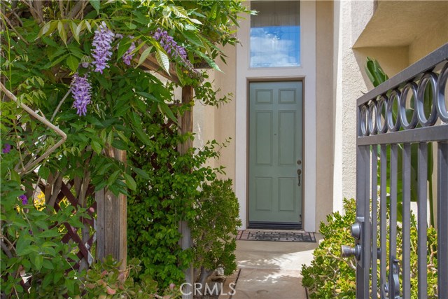 Wisteria covered Archway Leads to Courtyard to the Left