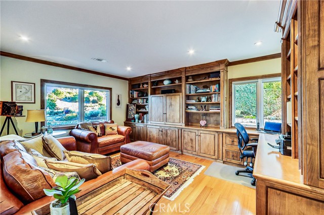 Bedroom 2 features extensive built in cabinetry and is used as a home office by this family.