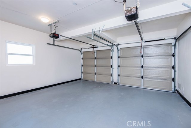 Garage with new surfaced floor and new garage doors