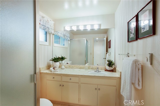 Full bath with privacy glass and shower next to first floor bedroom