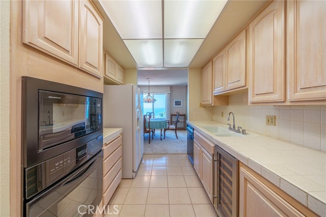 The Kitchen appliances include a New Wine refrigerator, microwave wall oven, range, and refrigerator.