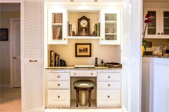 This custom built desk area can be hidden behind the louvered doors.