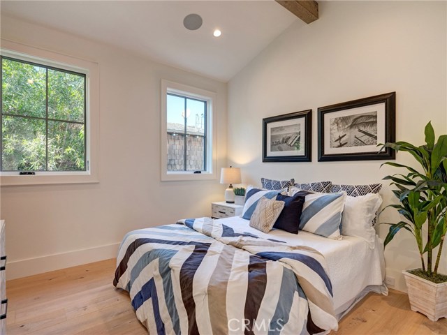 Upstairs bedroom suite #4 with Trestlewood reclaimed wood accent beam, en-suite bathroom.