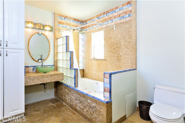 The custom remodeled Master Bath has ample use of stone and is very functional and comfortable.