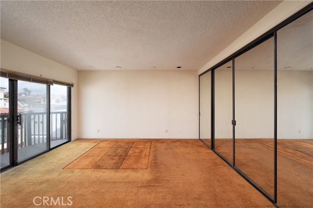 Premier bedroom with balcony.  Yes, the mirror closet doors are included in the sales price ;)