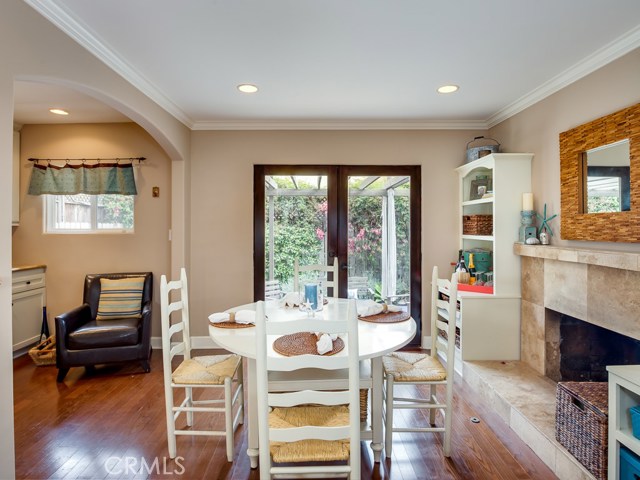 Dining room has wood floors and French doors that lead out to rear patio.