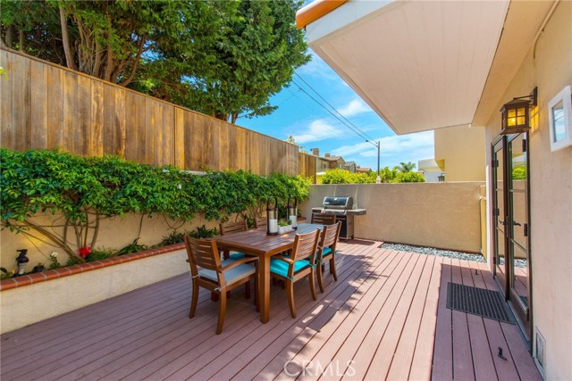 High wall and lush tree provide some shade and privacy