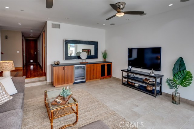 Living room on entry level with wine fridge and serving buffet