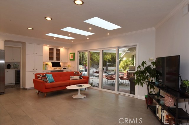 Pretty view of the family area off the kitchen with patio & rock pool beyond.