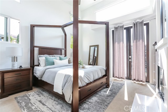 Master suite with high ceilings, fireplace & balcony