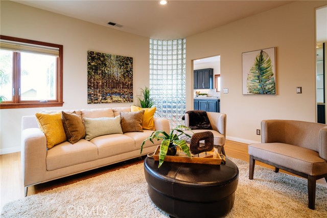 Living room with view of entry to kitchen