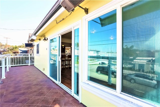 There is a large slider from the living room out to the wide deck which incorporates this area very well with the rest of the home home. The deck has glass wall railings and it fronts the width of the home and wraps around to the private side yard patio area.