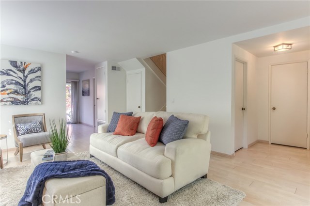 Living room with powder room and entry area on right side
