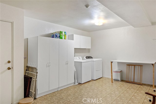 Garage level "bonis room has been upgraded with soffit to cover plumbing pipes. I do not think any of the other units have done this. Door leads to 2 car garage. Washer/dryer may be inc in sale but not warranted. Large room with storage is nice to have.
