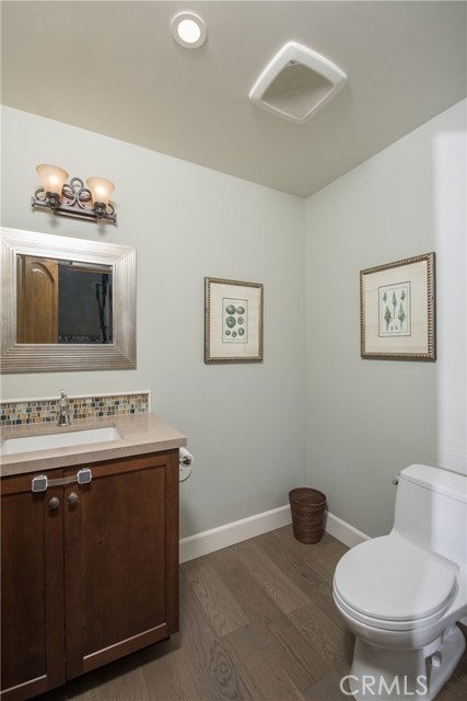 Half bath downstairs is super spacious, and has wide plank wood flooring.