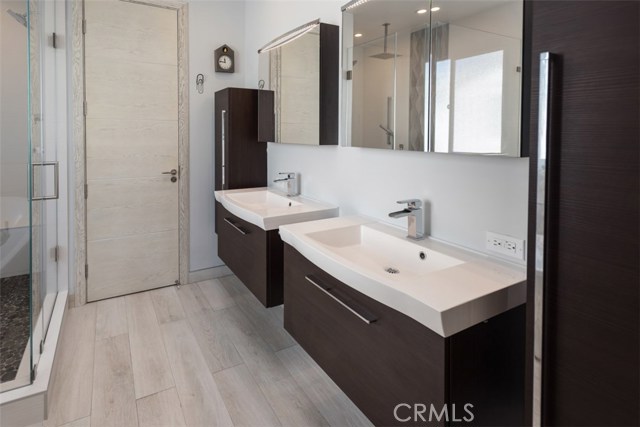 Master bath has separate sinks, separate toilet area and great storage